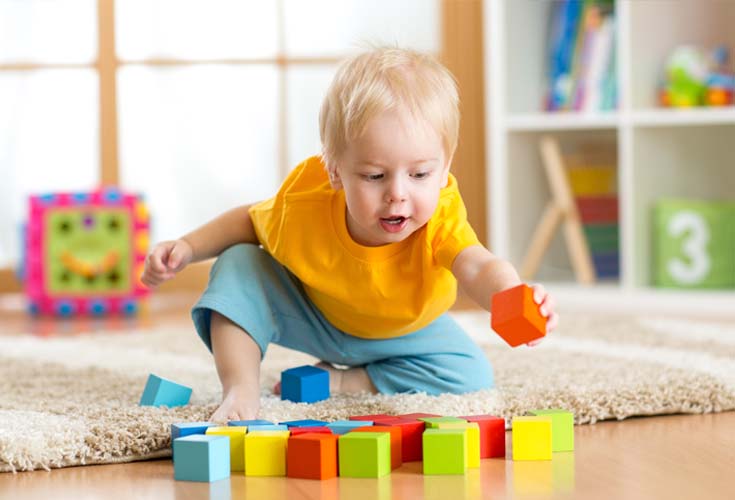 young boy building