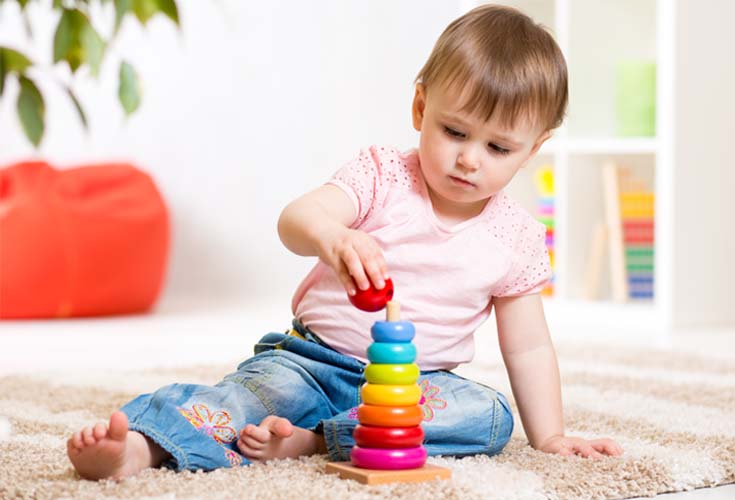 young child stacking